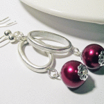 Red Glass Pearl Oval Link Dangle Earrings Laying Down